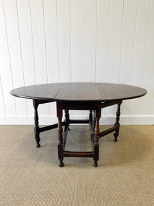 An Antique English Country Oak Drop Leaf Gate Leg Table