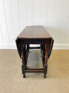 An Antique English Country Oak Drop Leaf Gate Leg Table