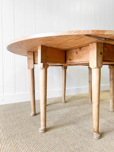 An Antique Pine Oval Drop Leaf Kitchen Dining Table with Spoon Feet