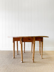 An Antique Pine Oval Drop Leaf Kitchen Dining Table with Spoon Feet