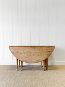 An Antique Pine Oval Drop Leaf Kitchen Dining Table with Spoon Feet