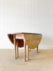 An Antique Pine Oval Drop Leaf Kitchen Dining Table with Spoon Feet