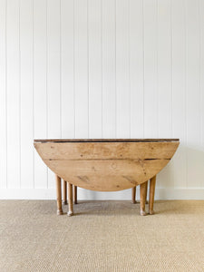 An Antique Pine Oval Drop Leaf Kitchen Dining Table with Spoon Feet