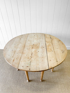 An Antique Pine Oval Drop Leaf Kitchen Dining Table with Spoon Feet